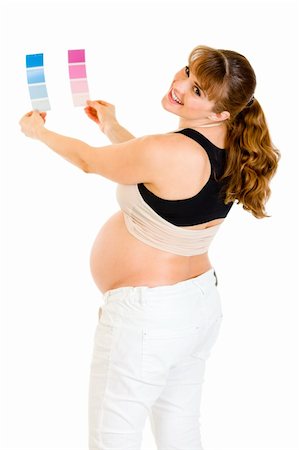 simsearch:400-04798379,k - Smiling pregnant woman holding color paint samples isolated on white Stock Photo - Budget Royalty-Free & Subscription, Code: 400-04243291