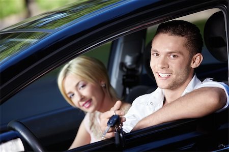 The happy couple with the keys in the car Stock Photo - Budget Royalty-Free & Subscription, Code: 400-04243429