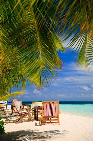 simsearch:851-02962651,k - Relaxing on tropical paradise with white sand at Maldives and green palms with blue sky Stock Photo - Budget Royalty-Free & Subscription, Code: 400-04257552
