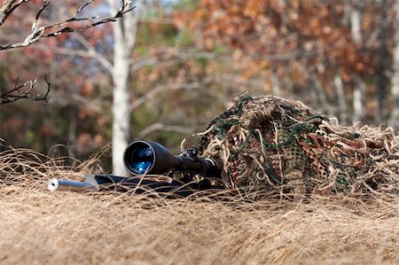 simsearch:400-04072400,k - sniper laying on the ground covered in a ghille suite tall grass and trees in the background Stock Photo - Budget Royalty-Free & Subscription, Code: 400-04259415