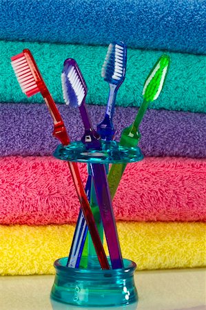 Toothbrush and bath towels against a white background in a studio environment Stock Photo - Budget Royalty-Free & Subscription, Code: 400-04266154