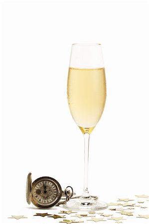 simsearch:600-01551669,k - cold glass of champagne with a old pocket watch and metal stars on white background Stock Photo - Budget Royalty-Free & Subscription, Code: 400-04266415