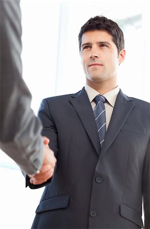 simsearch:400-04333648,k - Below view of a serious businessman concluding a deal with a partner at the office Stock Photo - Budget Royalty-Free & Subscription, Code: 400-04267352