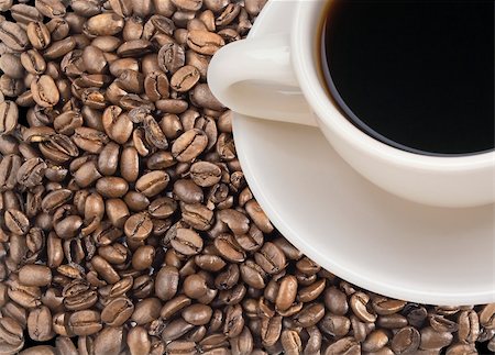 Freshly brewed coffee over dark roasted coffee beans Stock Photo - Budget Royalty-Free & Subscription, Code: 400-04268300