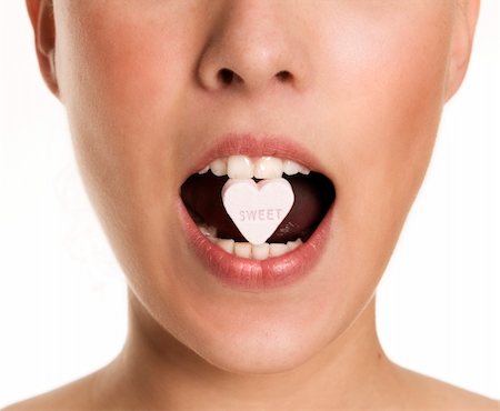 simsearch:400-07464468,k - a sweet heart of sugar between lips Stock Photo - Budget Royalty-Free & Subscription, Code: 400-04260866