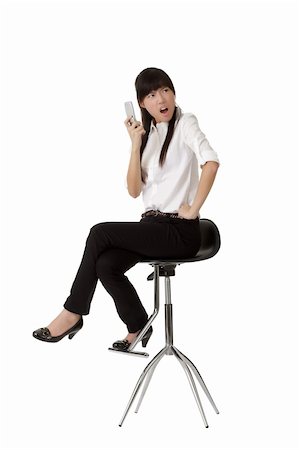 Angry business woman holding cellphone and siting on chair isolated over white background. Stock Photo - Budget Royalty-Free & Subscription, Code: 400-04261140