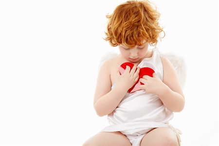 Small cupid presses to a breast the heart, isolated Stock Photo - Budget Royalty-Free & Subscription, Code: 400-04262986