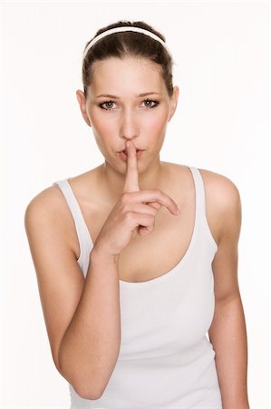 simsearch:400-04175955,k - Pretty young woman gestures quietness with pushing a finger on her lips Stock Photo - Budget Royalty-Free & Subscription, Code: 400-04276125