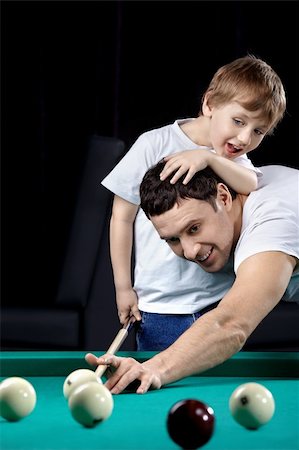 pool kids - The young man and the little boy play billiards Foto de stock - Super Valor sin royalties y Suscripción, Código: 400-04271220