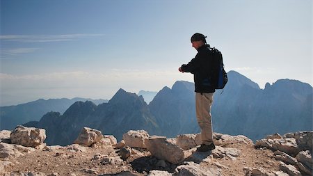 silhouette of man standing in a mountain top - Tourist at the end of his journey Stock Photo - Budget Royalty-Free & Subscription, Code: 400-04272561