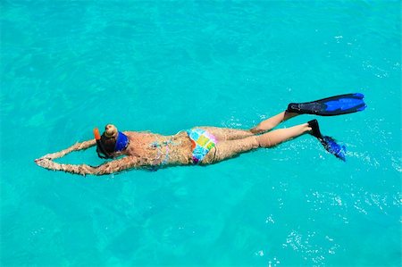 Young woman snorkeling in a tropical lagoon Stock Photo - Budget Royalty-Free & Subscription, Code: 400-04272872