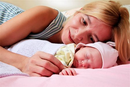 Mother with her sleeping newborn baby in home Stock Photo - Budget Royalty-Free & Subscription, Code: 400-04285522