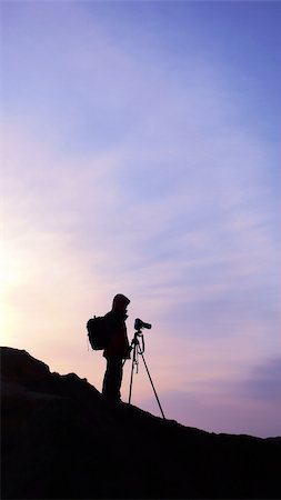 Silhouette of a photographer on the mountains at sunrise Stock Photo - Budget Royalty-Free & Subscription, Code: 400-04285795