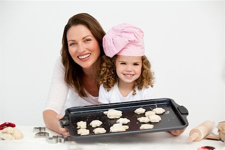 sugar mama - Happy mother and daughter showing a plate with biscuits to the camera Stock Photo - Budget Royalty-Free & Subscription, Code: 400-04287014