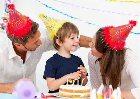 Attentive parents celebrating their son's birthday Stock Photo - Budget Royalty-Free & Subscription, Code: 400-04287033