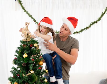 Cute daughter decorating the christmas tree with his father in the living room Stock Photo - Budget Royalty-Free & Subscription, Code: 400-04287050