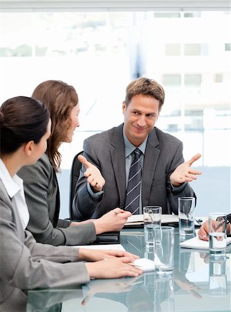 simsearch:400-05746962,k - Happy manager talking to his team sitting at a table Stock Photo - Budget Royalty-Free & Subscription, Code: 400-04287065