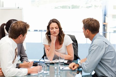 simsearch:400-05746962,k - Thoughtful businesswoman at a table with her team during a meeting Stock Photo - Budget Royalty-Free & Subscription, Code: 400-04287073