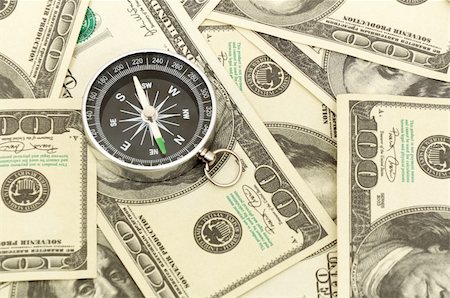 simsearch:400-05730288,k - Dollars and compass. Concept about a direction in business Stock Photo - Budget Royalty-Free & Subscription, Code: 400-04289073