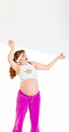 simsearch:400-04798379,k - Surprised beautiful pregnant woman holding blank billboard over her head isolated on white Stock Photo - Budget Royalty-Free & Subscription, Code: 400-04294348