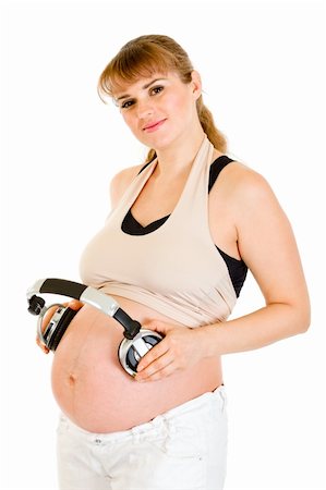 simsearch:400-04817039,k - Smiling pregnant woman holding headphones on her tummy isolated on white Stock Photo - Budget Royalty-Free & Subscription, Code: 400-04294378