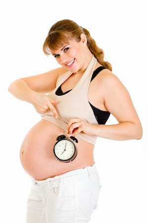 simsearch:400-04817039,k - Smiling pregnant woman pointing on alarm clock isolated on white Stock Photo - Budget Royalty-Free & Subscription, Code: 400-04294373