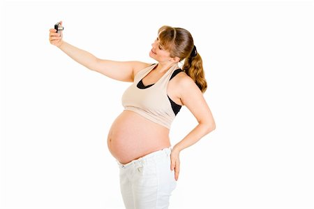 simsearch:400-04817039,k - Smiling pregnant woman photographing herself isolated on white Stock Photo - Budget Royalty-Free & Subscription, Code: 400-04294390