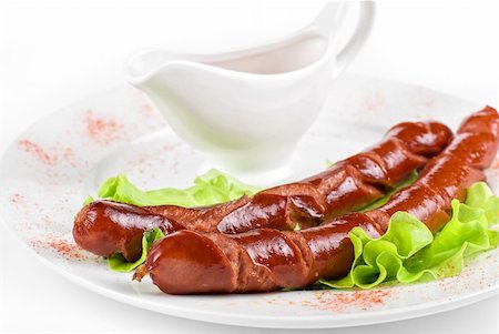 simsearch:400-04587885,k - grilled sausage closeup with lettuce and sauce isolated on white Stock Photo - Budget Royalty-Free & Subscription, Code: 400-04295185