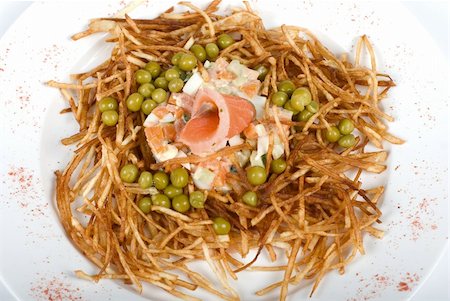 simsearch:400-06864386,k - Closeup of salad with salmon fish at fried sliced potato with carrot and peas dressed by tomato sauce with cognac Stock Photo - Budget Royalty-Free & Subscription, Code: 400-04295180