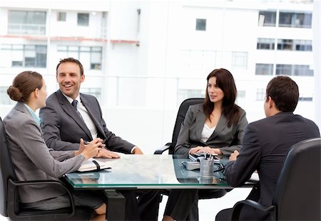 simsearch:400-05746962,k - Handsome manager laughing during a meeting with his team at work Stock Photo - Budget Royalty-Free & Subscription, Code: 400-04296689