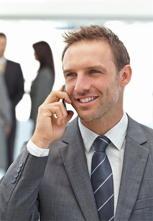 simsearch:400-05746962,k - Successful businessman on the phone during a meeting with his team Stock Photo - Budget Royalty-Free & Subscription, Code: 400-04296707