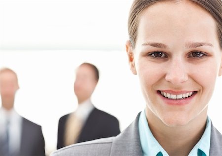 simsearch:400-05746962,k - Young businesswoman posing in front of two businessmen standing on the background Stock Photo - Budget Royalty-Free & Subscription, Code: 400-04296716