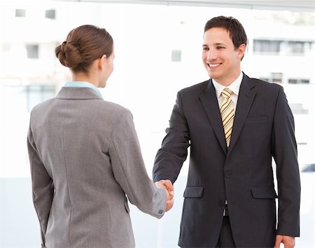 simsearch:400-04333648,k - Cheerful businessman and businesswoman concluding a deal by shaking hands Stock Photo - Budget Royalty-Free & Subscription, Code: 400-04296720