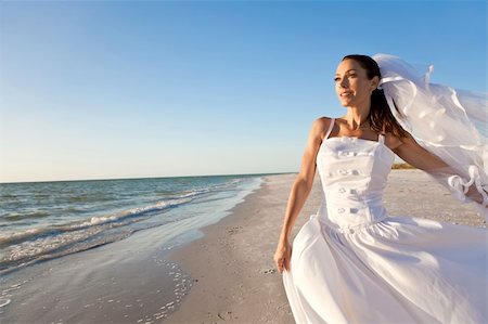 A married woman bride in her wedding dress in golden evening sunshine on a beautiful tropical beach Stock Photo - Budget Royalty-Free & Subscription, Code: 400-04296856