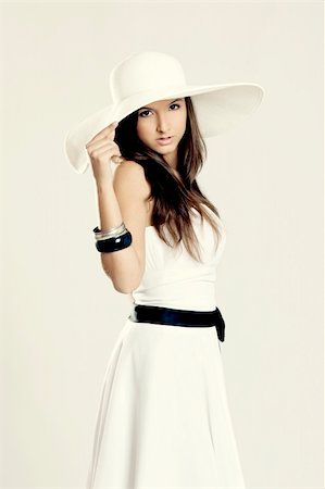 simsearch:400-04655693,k - Beautiful and fashion young woman posing and wearing a wonderful white dress with a white hat Stock Photo - Budget Royalty-Free & Subscription, Code: 400-04297998