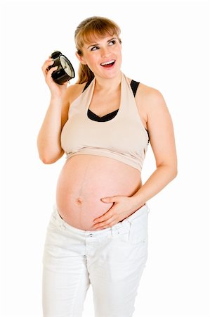 simsearch:400-04817039,k - Baby on way! Smiling pregnant woman holding alarm clock isolated on white Stock Photo - Budget Royalty-Free & Subscription, Code: 400-04306012