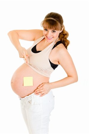 simsearch:400-04798379,k - Smiling pregnant woman pointing on blank sticky note on her belly isolated on white Stock Photo - Budget Royalty-Free & Subscription, Code: 400-04306022
