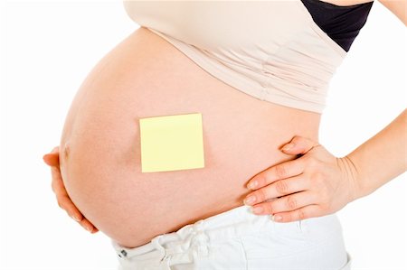simsearch:400-04798379,k - Pregnant woman with blank sticky note on her belly isolated on white. Close-up. Stock Photo - Budget Royalty-Free & Subscription, Code: 400-04306023