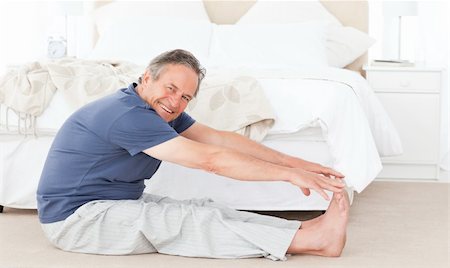 Mature man stretching in his bedroom Stock Photo - Budget Royalty-Free & Subscription, Code: 400-04306510