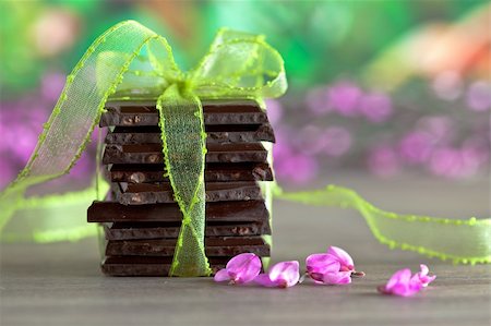 simsearch:400-05136453,k - Decorative Stack of Chocolate with green ribbon and small pink flowers Stock Photo - Budget Royalty-Free & Subscription, Code: 400-04307137