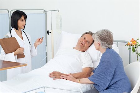 retired doctor - Nurse talking with a couple in a hospital Stock Photo - Budget Royalty-Free & Subscription, Code: 400-04307816