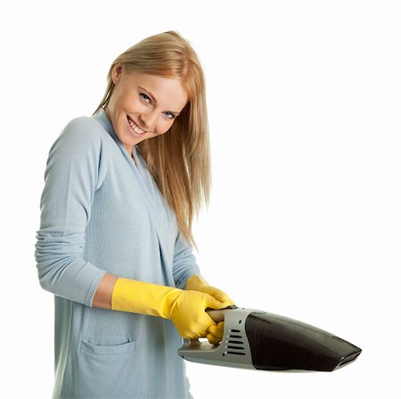 simsearch:400-07902993,k - Cheerful woman with handheld vacuum cleaner. Isolated on white Photographie de stock - Aubaine LD & Abonnement, Code: 400-04308332