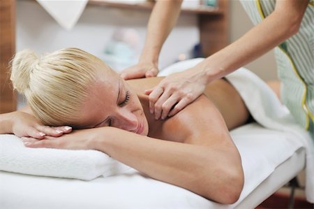 simsearch:400-05352124,k - A pretty woman getting a shoulder and back massage at spa and wellness center Stock Photo - Budget Royalty-Free & Subscription, Code: 400-04309455