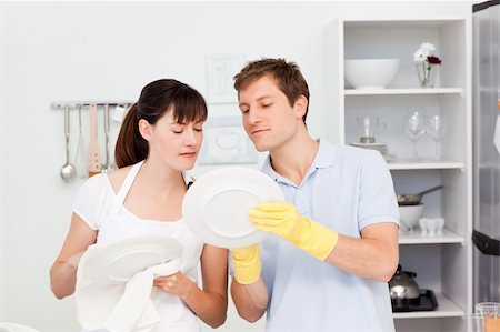 Lovers washing dishes together in their kitchen Stock Photo - Budget Royalty-Free & Subscription, Code: 400-04300854