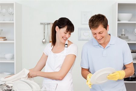 Lovers washing dishes together in their kitchen Stock Photo - Budget Royalty-Free & Subscription, Code: 400-04300856