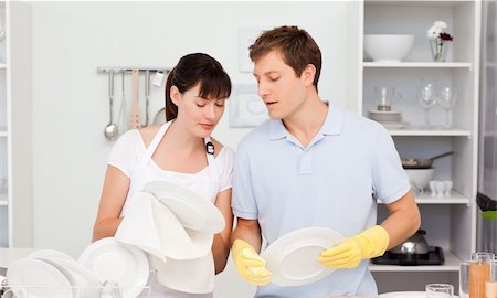 Lovers washing dishes together in their kitchen Stock Photo - Budget Royalty-Free & Subscription, Code: 400-04300853