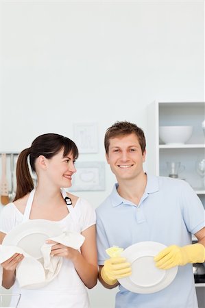Lovers washing dishes together in their kitchen Stock Photo - Budget Royalty-Free & Subscription, Code: 400-04300860