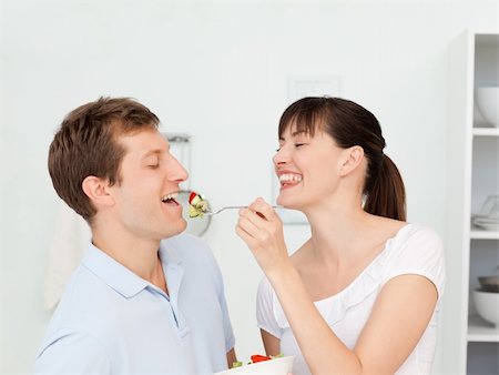 simsearch:400-05744780,k - Happy couple eating together in the kitchen Stock Photo - Budget Royalty-Free & Subscription, Code: 400-04300874