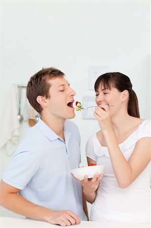 simsearch:400-05744780,k - Happy couple eating together in the kitchen Stock Photo - Budget Royalty-Free & Subscription, Code: 400-04300875