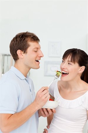 simsearch:400-05744780,k - Happy couple eating together in the kitchen Stock Photo - Budget Royalty-Free & Subscription, Code: 400-04300876